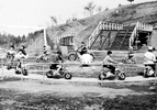 2009年まで日野市程久保にあった、モータースポーツをテーマとした遊園地「多摩テック」のアトラクションに乗る子どもたちの姿を写した写真です。